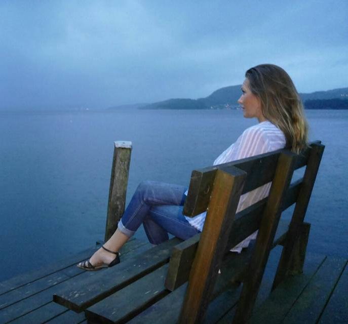 Caroline sitter i stillhet vid havet